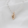 A small 9ct gold heart pendant attached to a sterling silver belcher chain necklace, displayed on a white background.