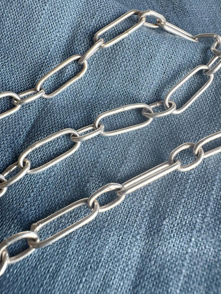 Metal chain on a blue denim background