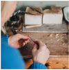 Lady working at jewellery bench with files