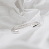 Sterling Silver cuff with hallmark on white material 