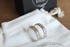 Silver rings on a white jewellery pouch with 'Fred & Emily Jewellery' branding.