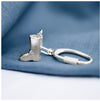 A sterling silver keyring in the shape of a handmade wellington boot on a blue textured background.