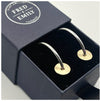 Silver hoops with a gold filled disc, textured to create a sparkle sitting in a blue Fred & Emily Jewellery Box