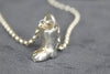 Small silver boot on blue surface