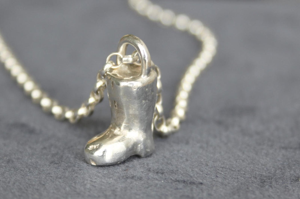 Small silver boot on blue surface