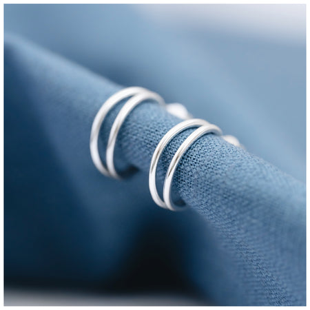 Sterling silver hoops with a double strand on a white background