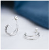 Sterling silver hoops with a double strand on a white background