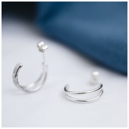 Sterling silver hoops with a double strand on a white background