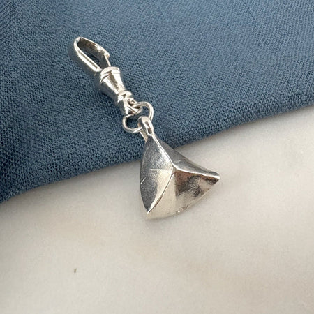 Silver summit charm on a blue and white background