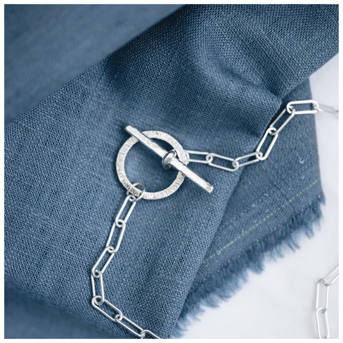 A Trace Chain necklace with a decorative t bar and clasp at the front