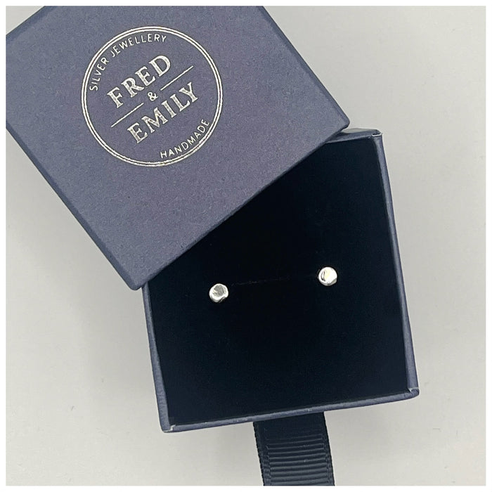 Tiny dot studs or earrings made from  sterling silver in a blue Fred & Emily Box