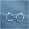 silver halo circle earrings on a contrasting blue linen background